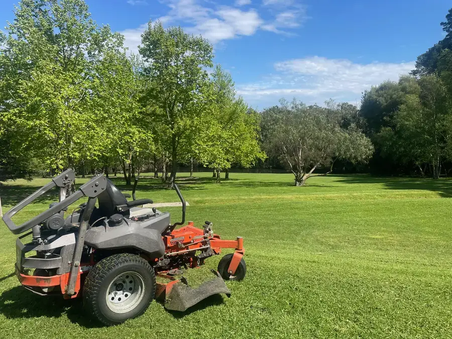 Zero-turn ride-on mower on an open acreage property